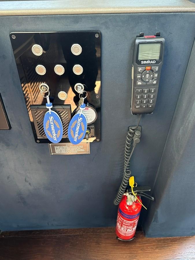 a wall with a clock and a box with a keychain aboard K NUK Yacht for Sale