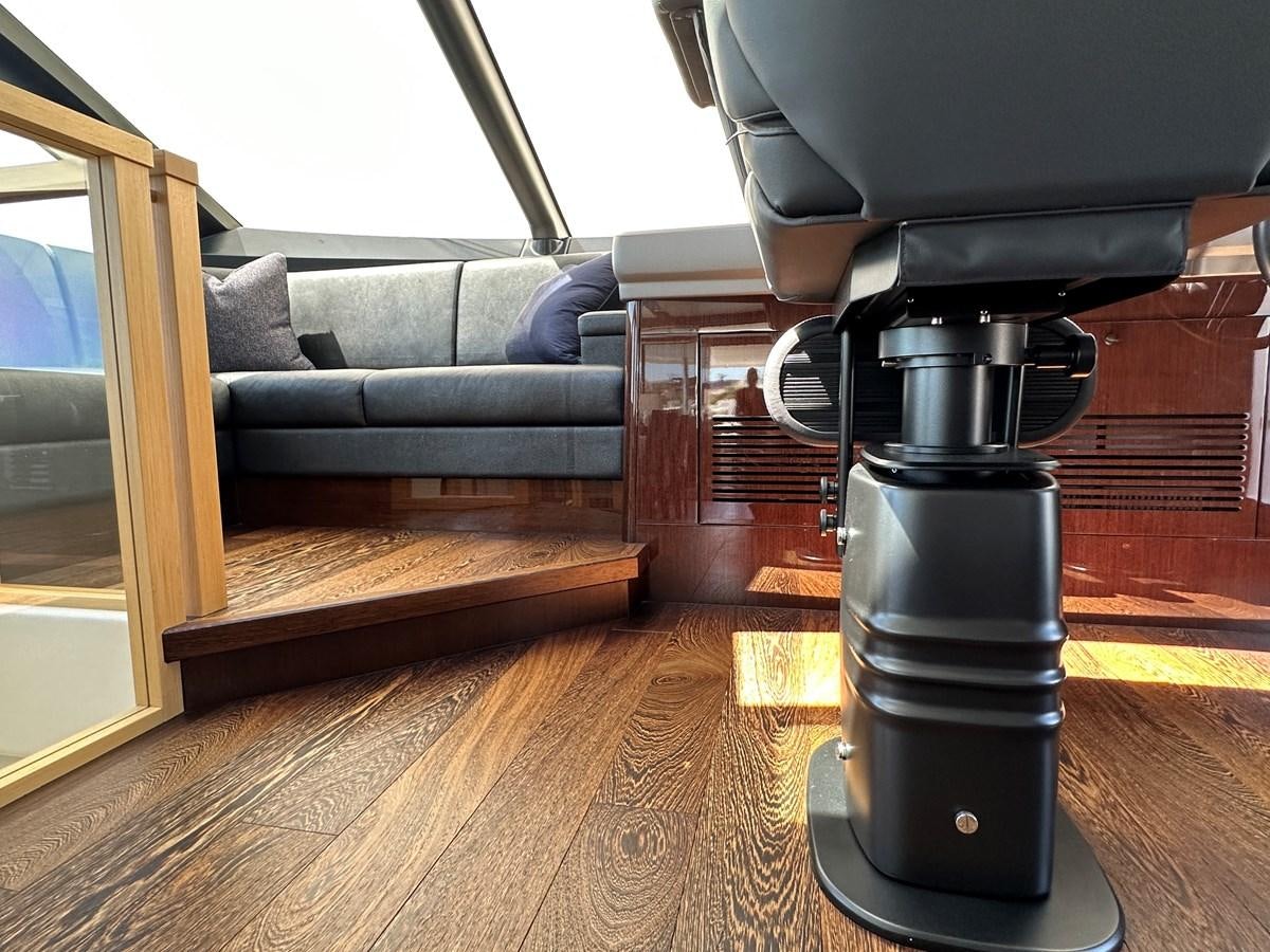 a black coffee machine on a wooden floor in a room with a couch and a wood floor aboard K NUK Yacht for Sale