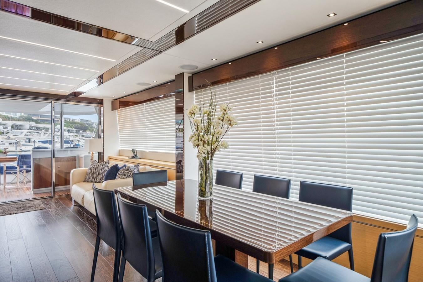 a room with a table chairs and a plant in it aboard K NUK Yacht for Sale