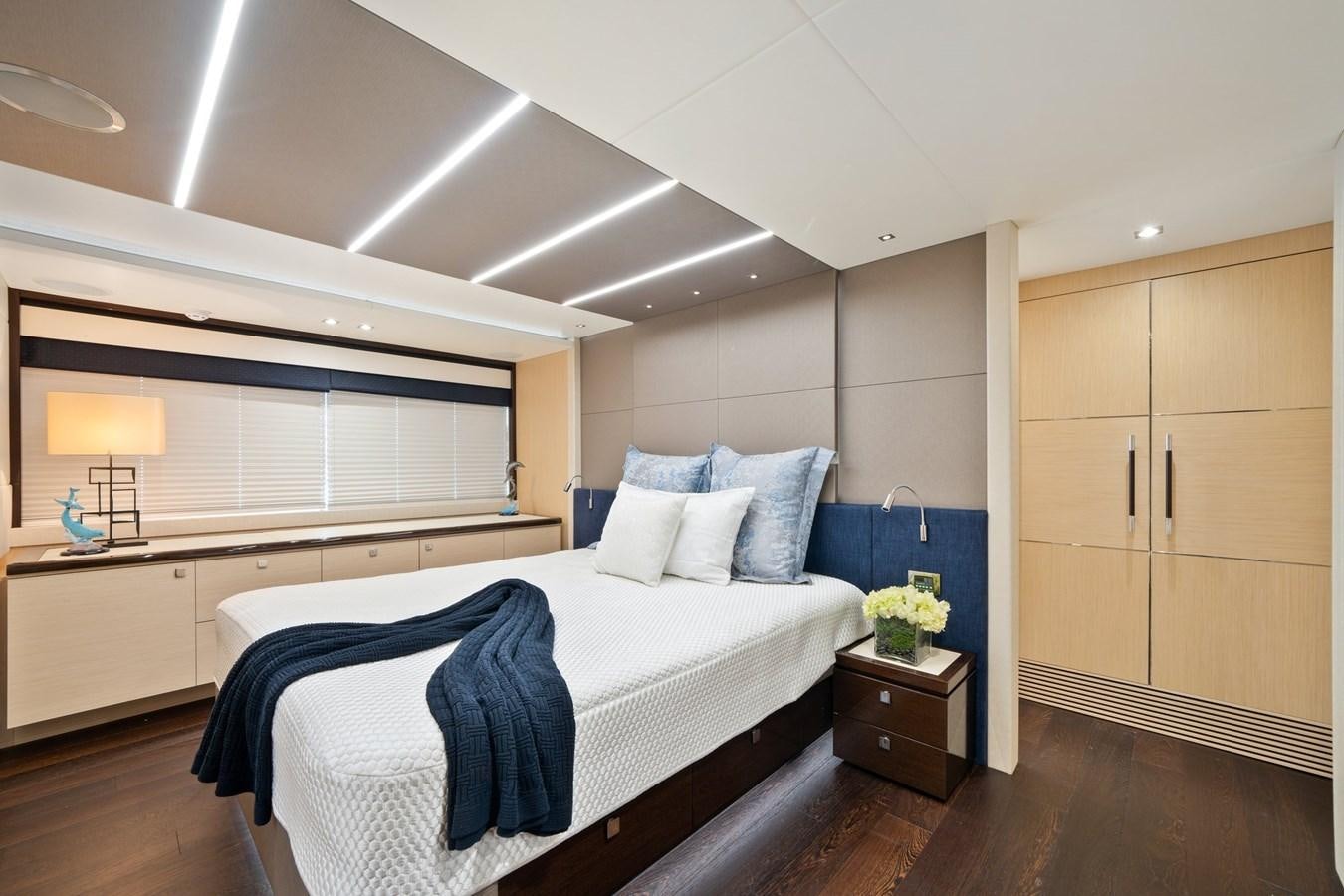 a modern bedroom with a large bed aboard K NUK Yacht for Sale