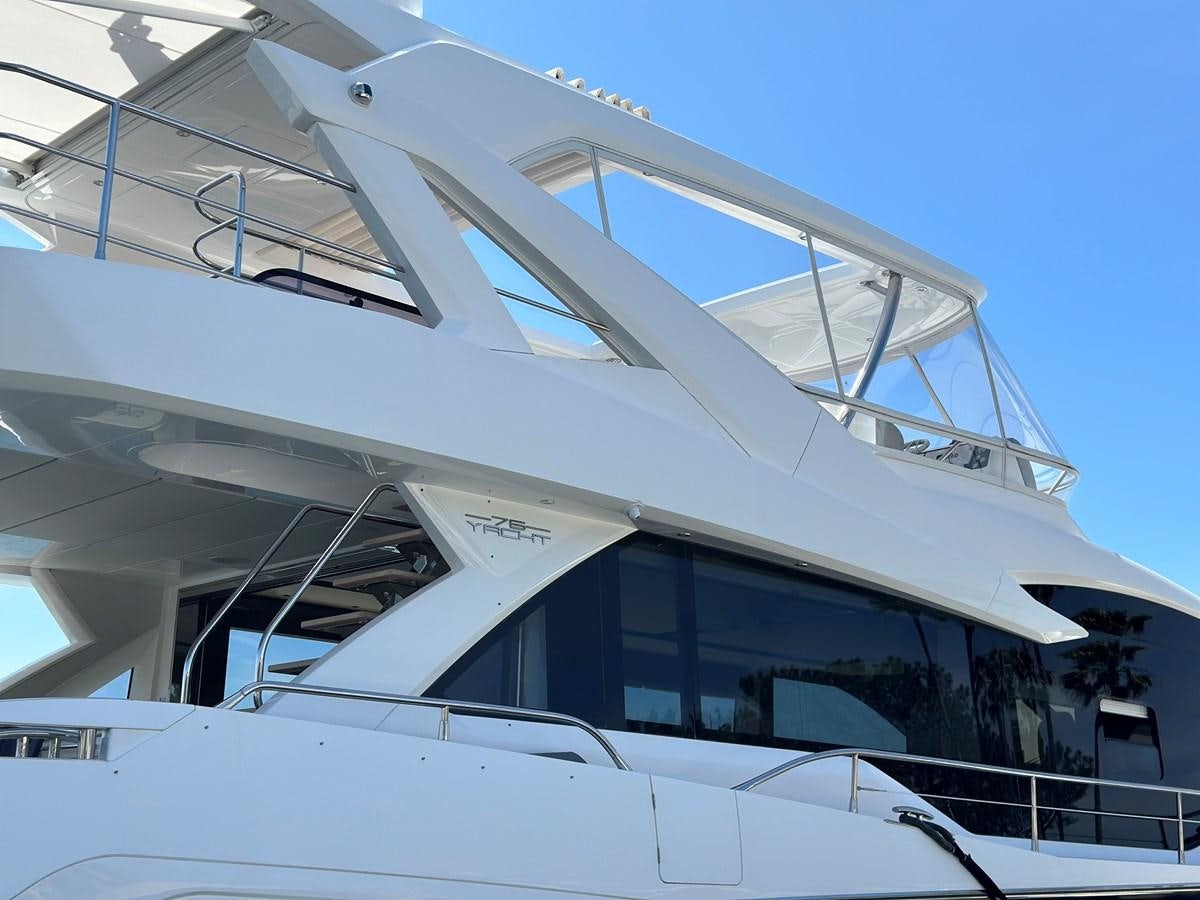 a white boat with a blue sky aboard K NUK Yacht for Sale