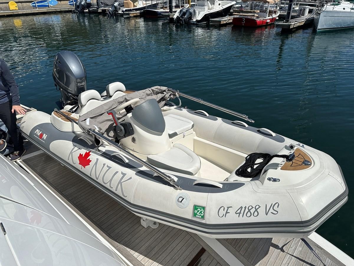 a white boat with a helmet on it aboard K NUK Yacht for Sale