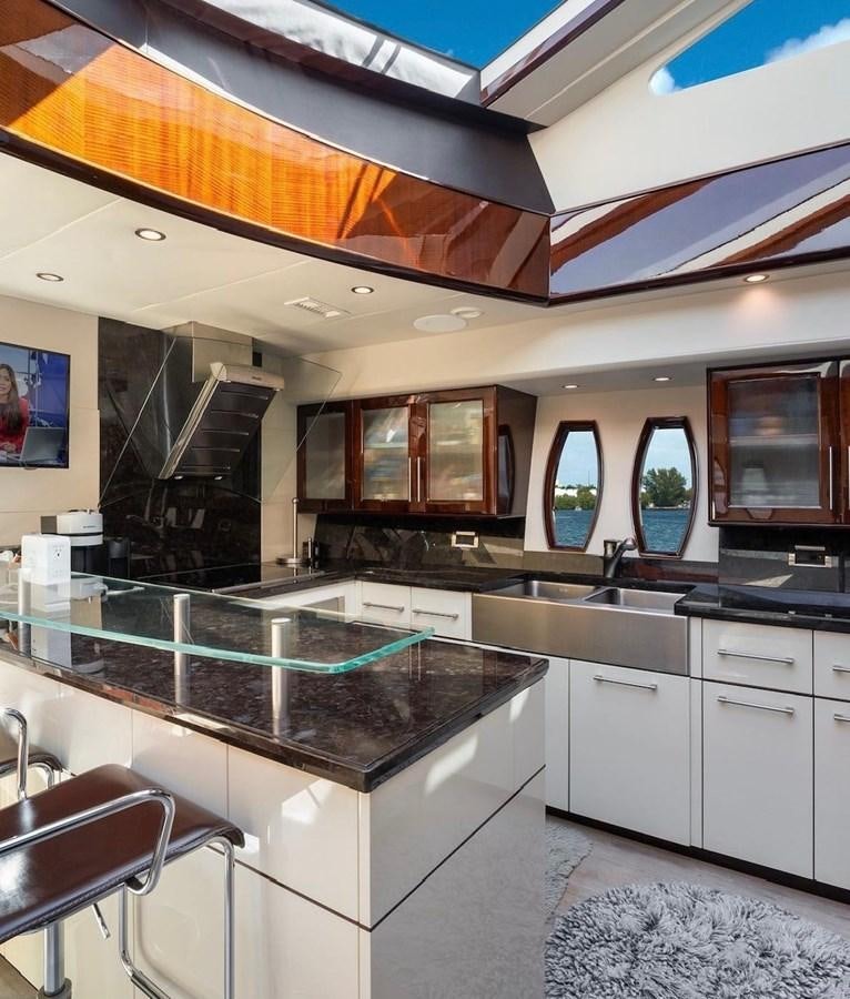 a kitchen with a bar and a bar on the ceiling aboard XCELL Yacht for Sale
