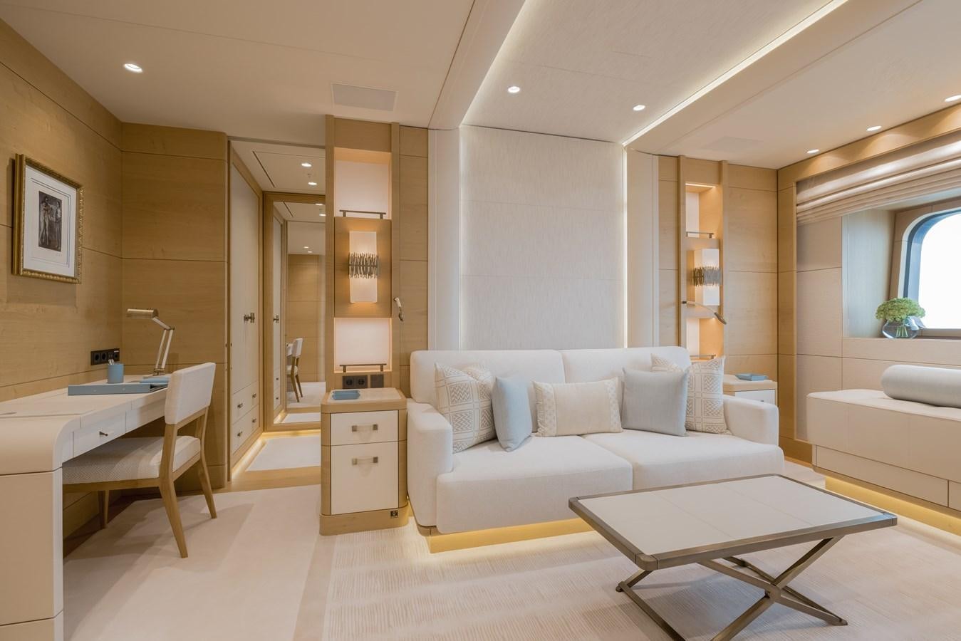 a living room with a white couch and a table aboard HERE COMES THE SUN Yacht for Sale