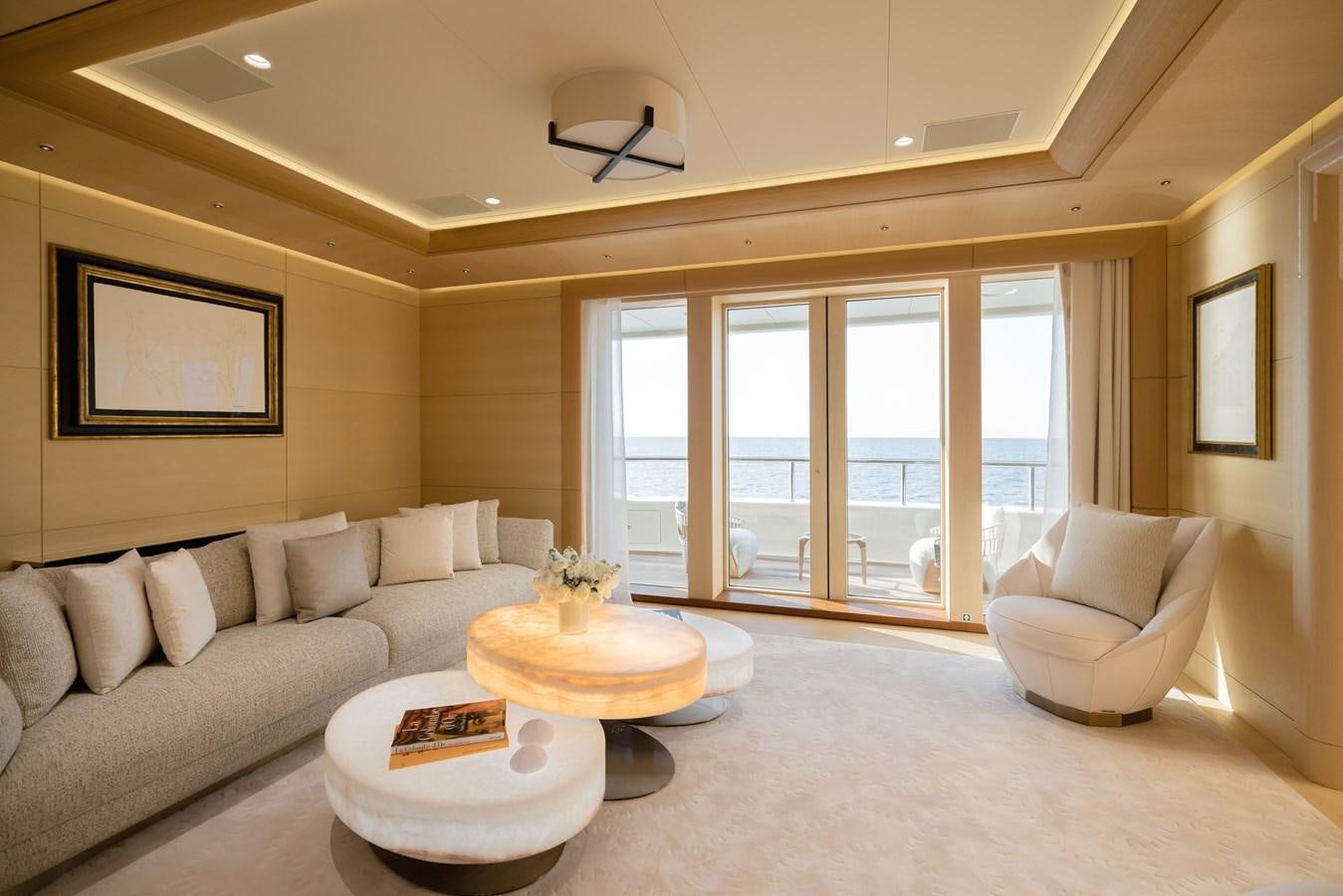 a living room with a couch and a table aboard HERE COMES THE SUN Yacht for Sale