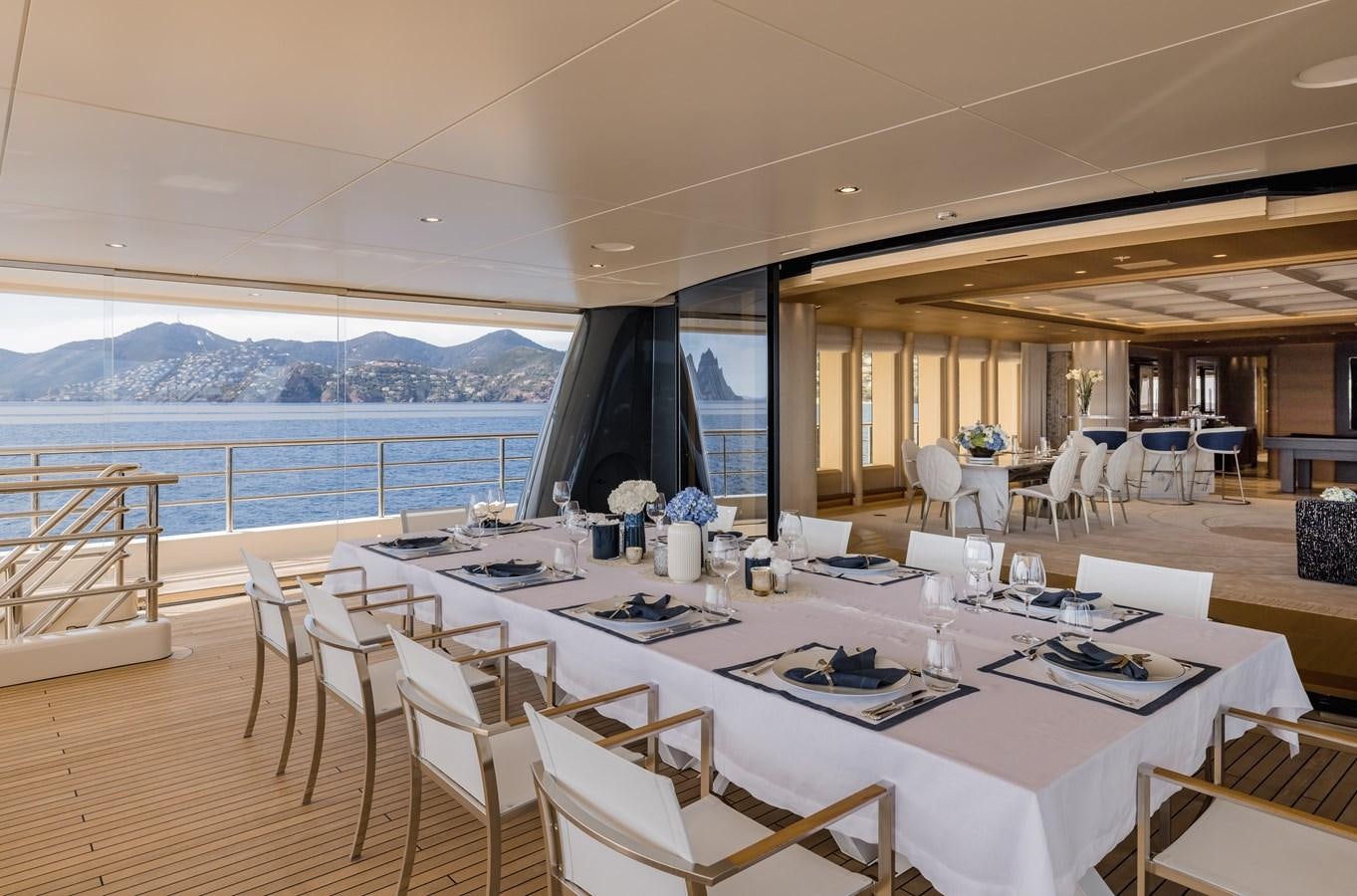 a room with tables and chairs aboard HERE COMES THE SUN Yacht for Sale