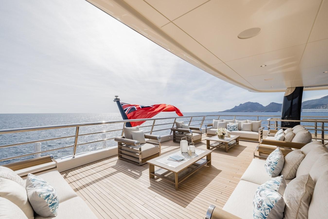 a large living room with a large balcony aboard HERE COMES THE SUN Yacht for Sale