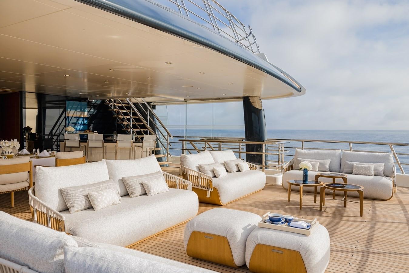 a living room with white furniture aboard HERE COMES THE SUN Yacht for Sale