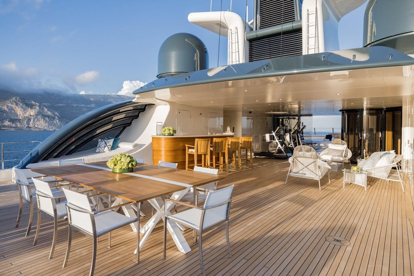 a deck with a table and chairs aboard HERE COMES THE SUN Yacht for Sale