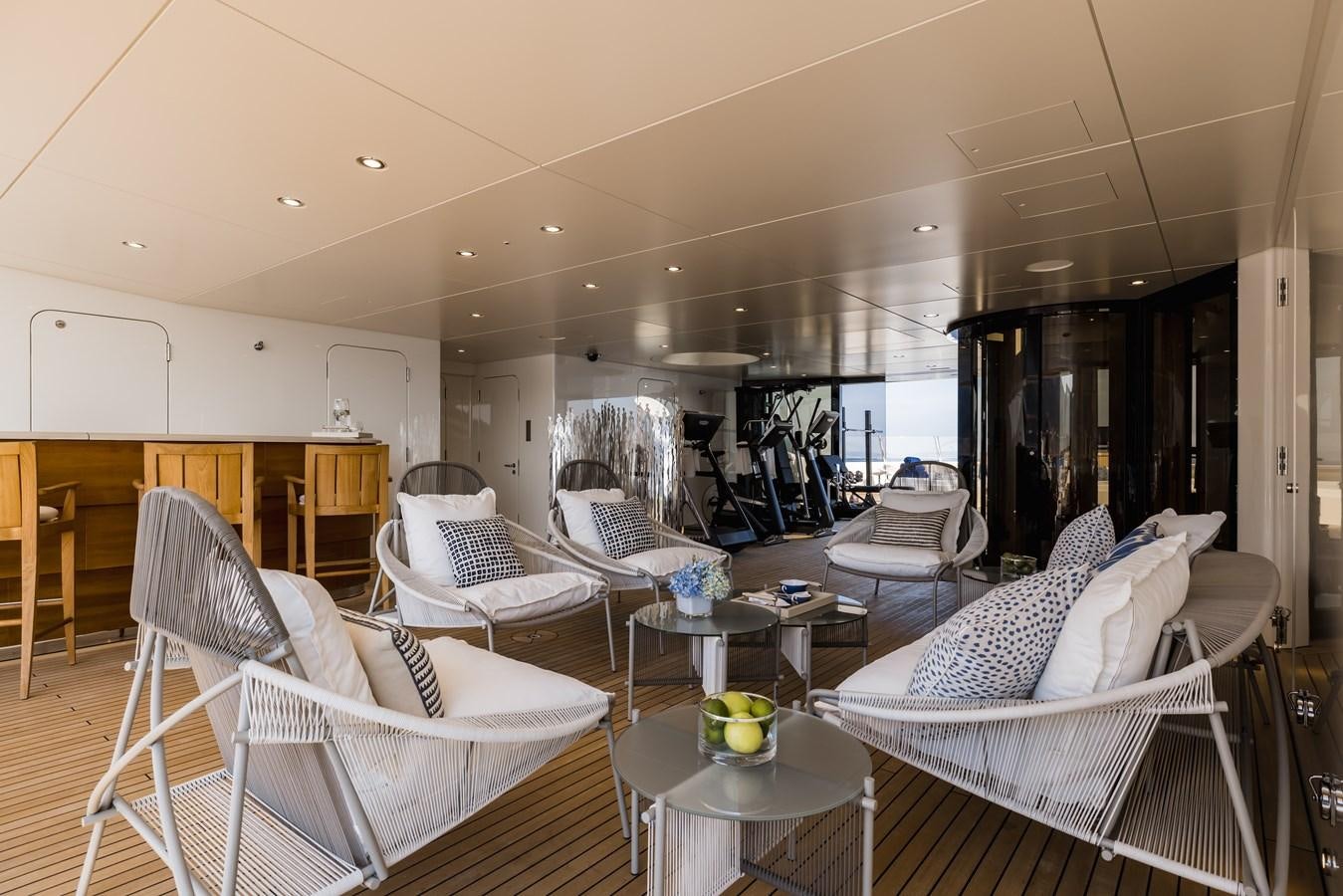 a living room with white furniture aboard HERE COMES THE SUN Yacht for Sale