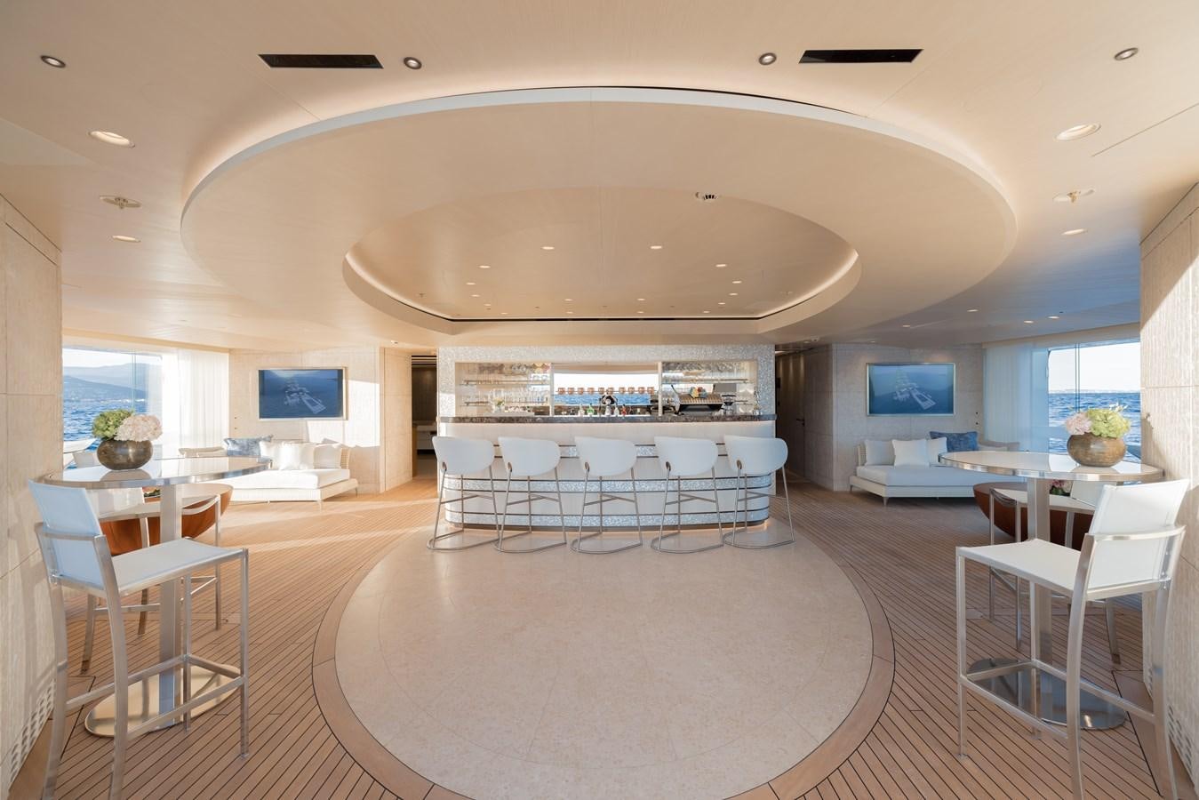 a large room with tables and chairs aboard HERE COMES THE SUN Yacht for Sale