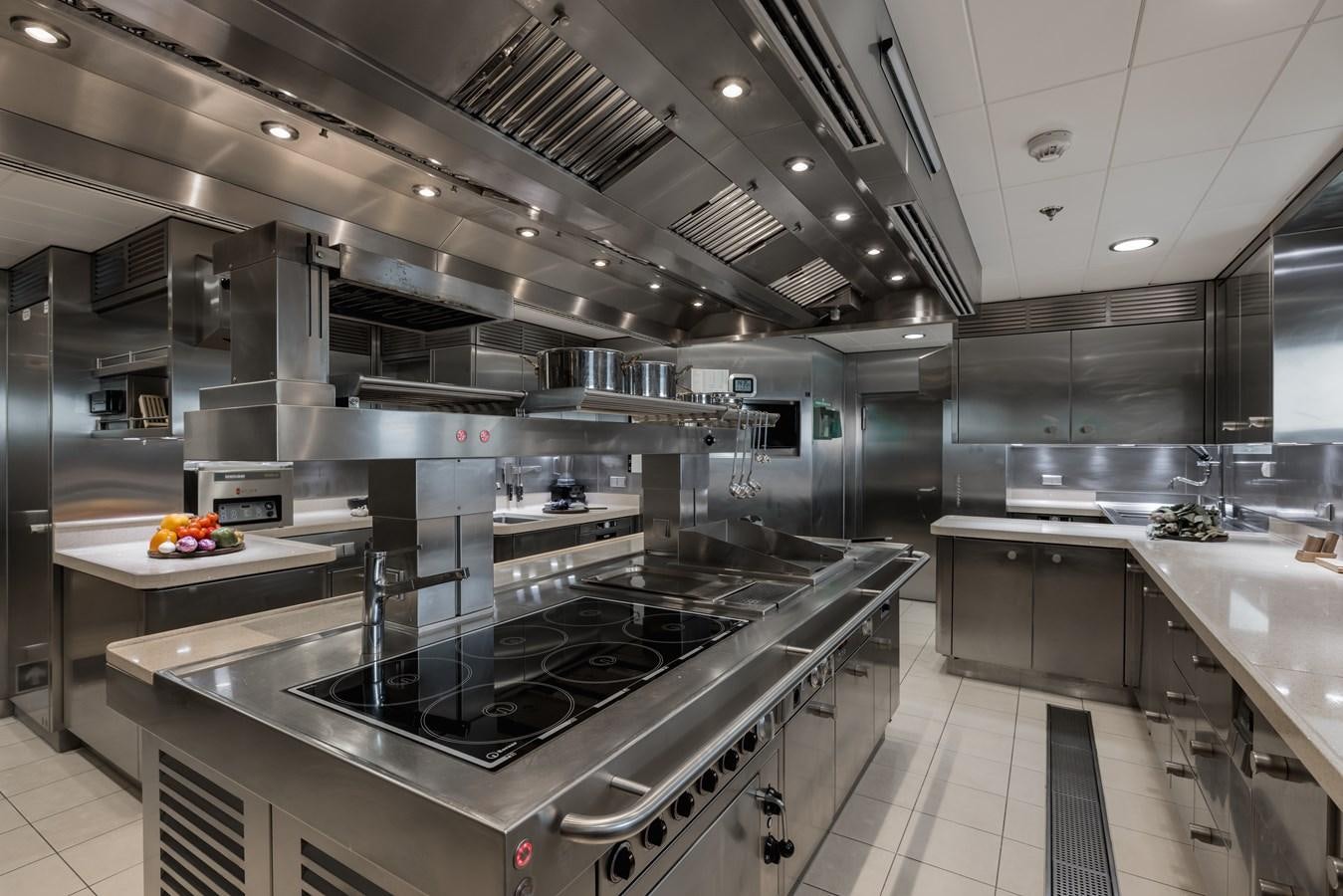 a kitchen with stainless steel appliances aboard HERE COMES THE SUN Yacht for Sale
