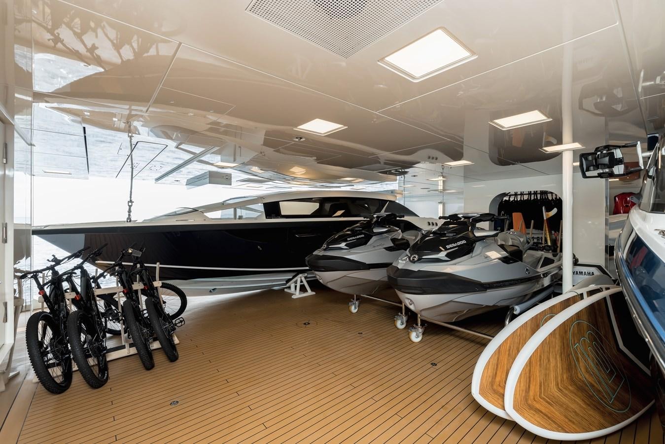 a room with a row of bicycles and a large mirror aboard HERE COMES THE SUN Yacht for Sale