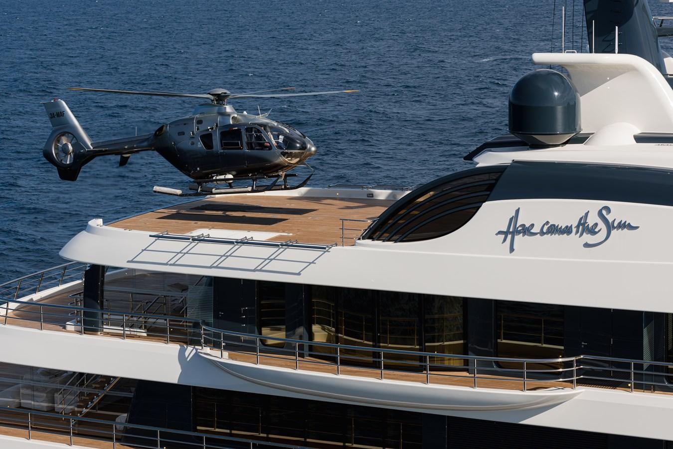 a helicopter flying over a boat aboard HERE COMES THE SUN Yacht for Sale