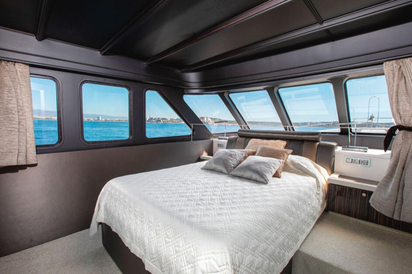 a car with a bed and a pillow on the seat aboard RA Yacht for Sale