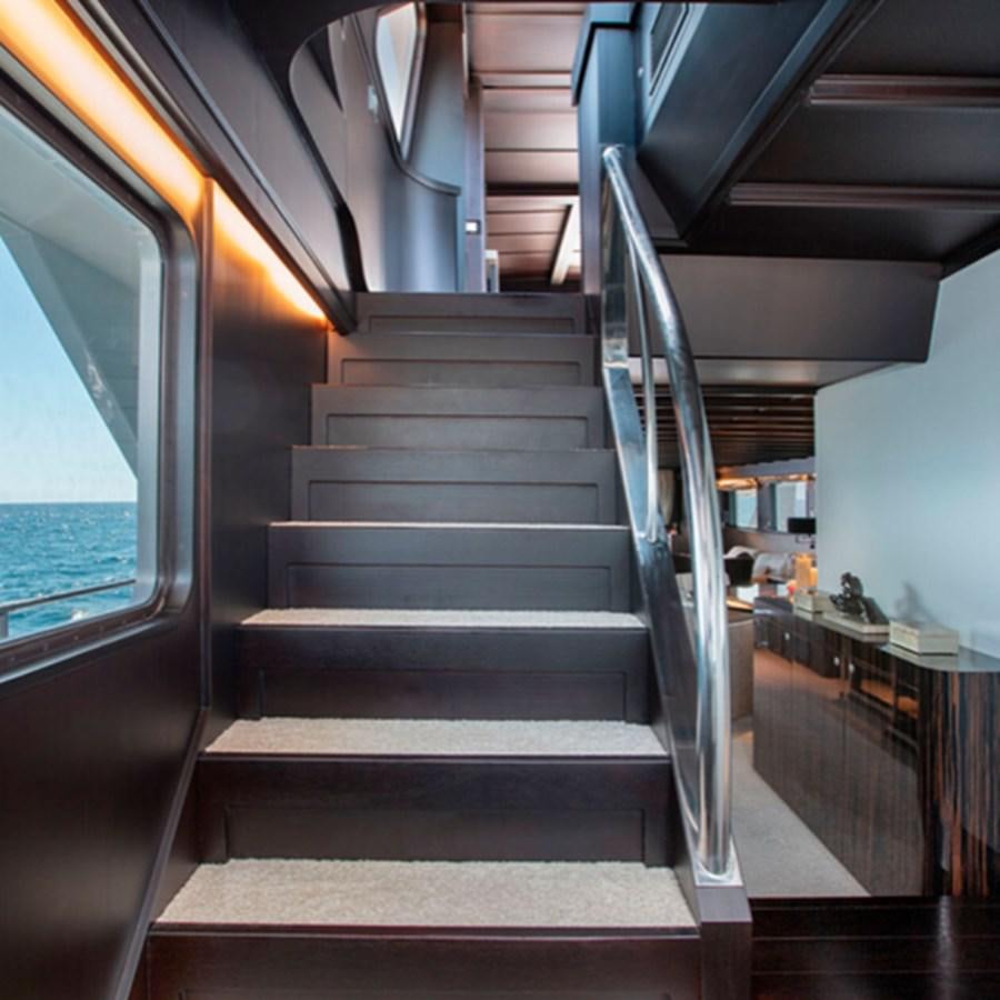a staircase with a glass door aboard RA Yacht for Sale