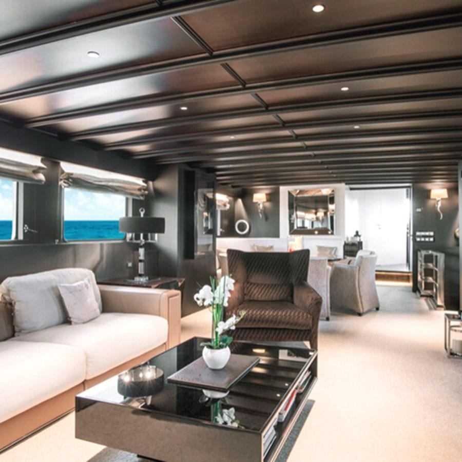 a living room with a couch and a coffee table aboard RA Yacht for Sale