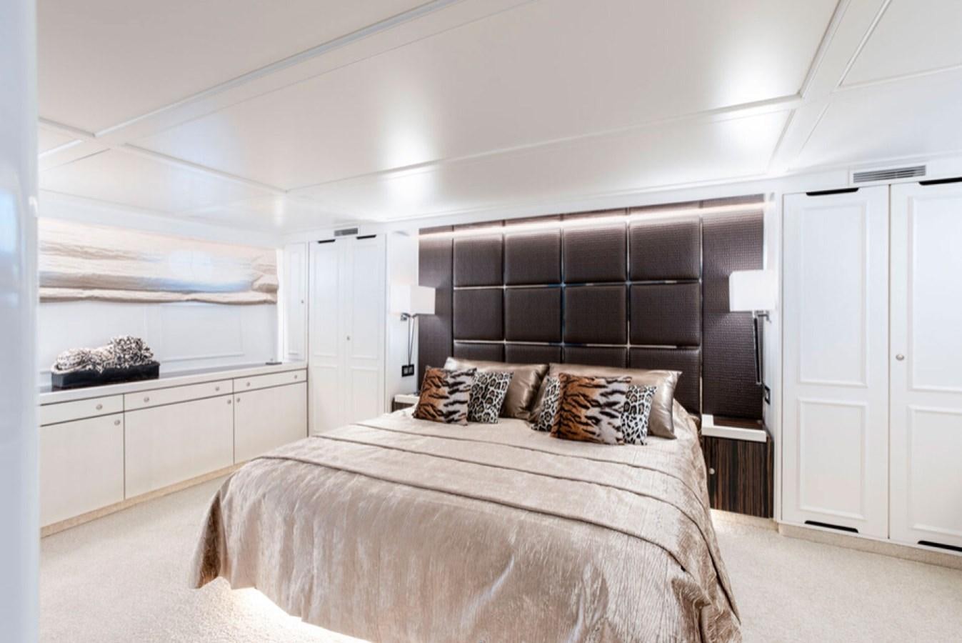 a bedroom with a large bed aboard RA Yacht for Sale