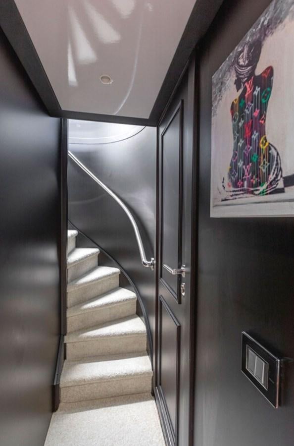 a black staircase with a white wall aboard RA Yacht for Sale