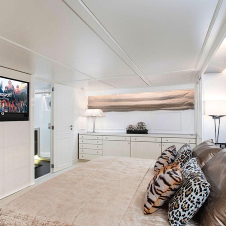 a large living room with a large sofa and a large mirror aboard RA Yacht for Sale