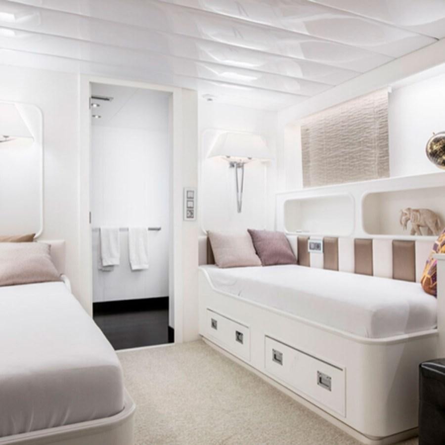 a white bedroom with a white bed aboard RA Yacht for Sale