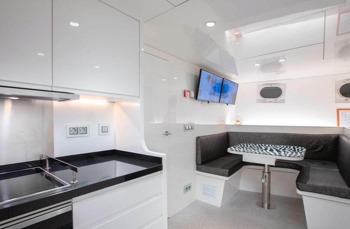 a room with a bed and a desk aboard RA Yacht for Sale