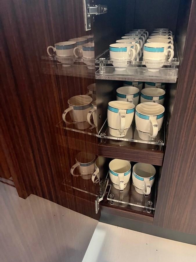 a shelf with cups and cups on it aboard PERRI BEACH Yacht for Sale