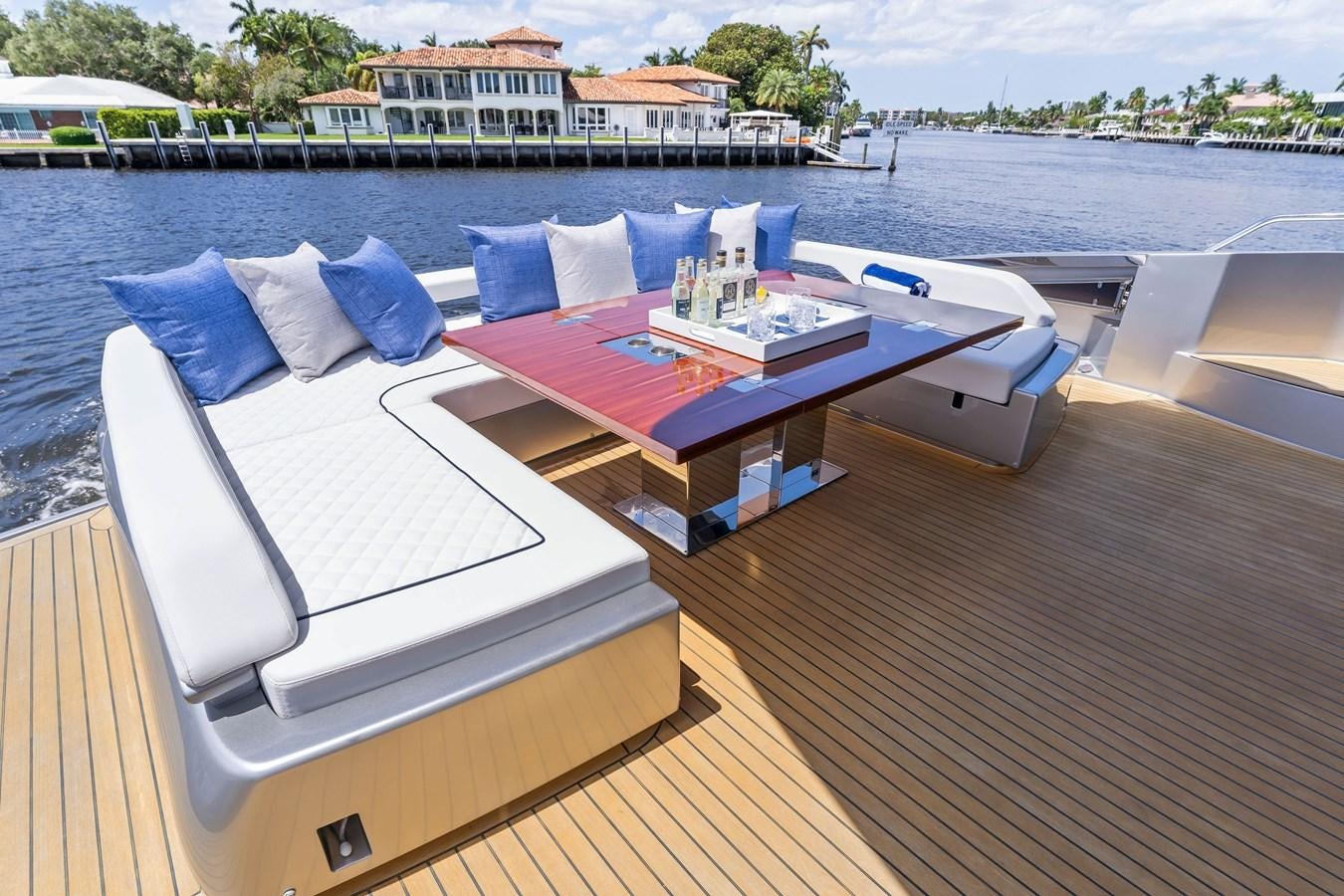 a deck with a pool and a deck with chairs and a building in the background aboard PERRI BEACH Yacht for Sale