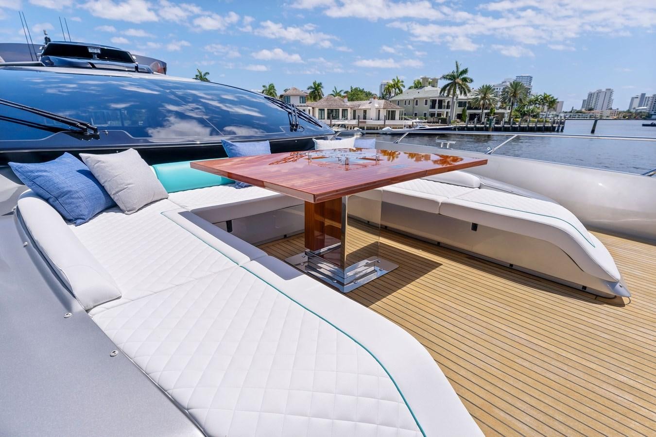 a deck with a table and chairs on it aboard PERRI BEACH Yacht for Sale