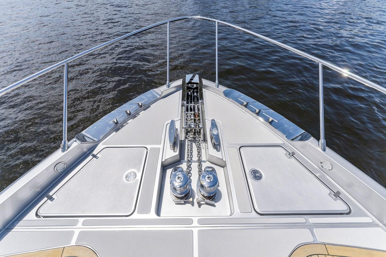 a white boat with blue water and a white rope aboard PERRI BEACH Yacht for Sale