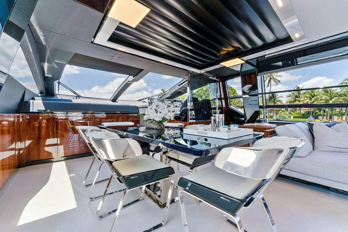 a room with a table chairs and a couch aboard PERRI BEACH Yacht for Sale