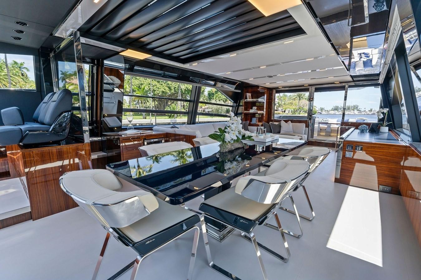 a room with tables and chairs aboard PERRI BEACH Yacht for Sale
