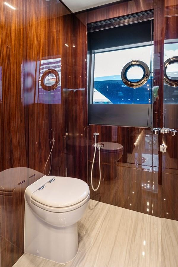 a bathroom with a toilet and a window aboard PERRI BEACH Yacht for Sale