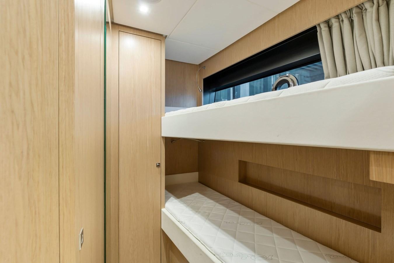 a room with a wood cabinet and a black stove aboard PERRI BEACH Yacht for Sale