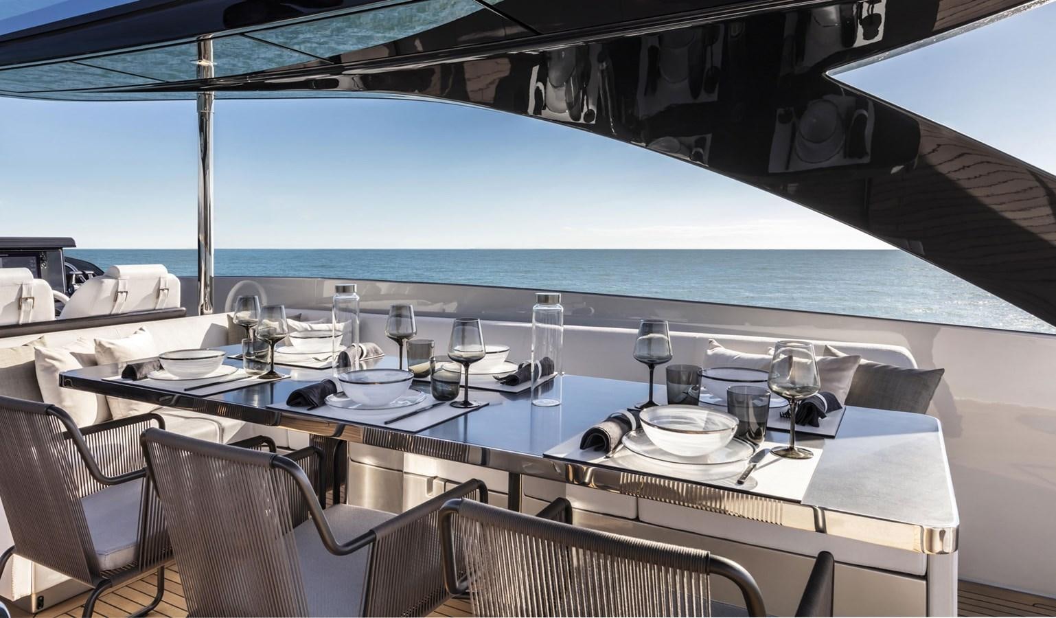 a table with glasses and plates on it aboard UNDISCLOSED Yacht for Sale