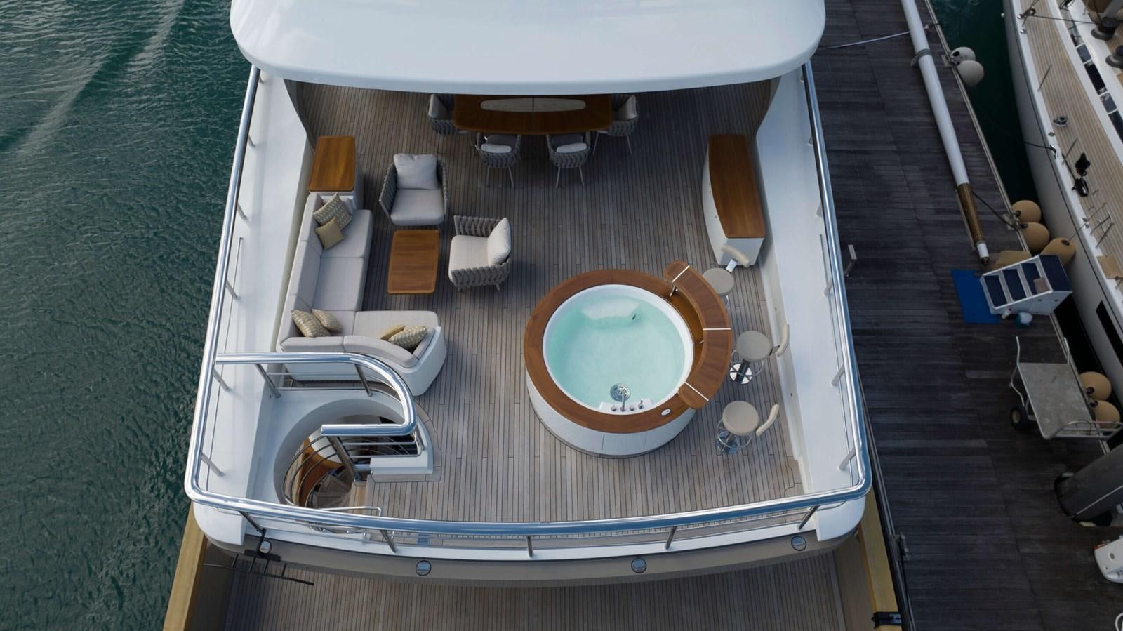 a swimming pool with a table and chairs aboard AMIKA Yacht for Sale