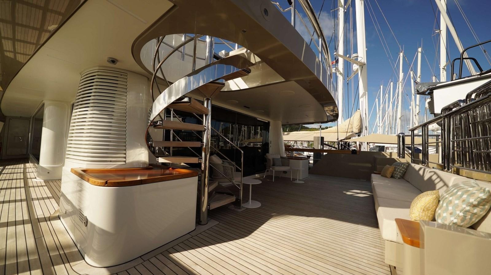 a room with a staircase and a couch aboard AMIKA Yacht for Sale