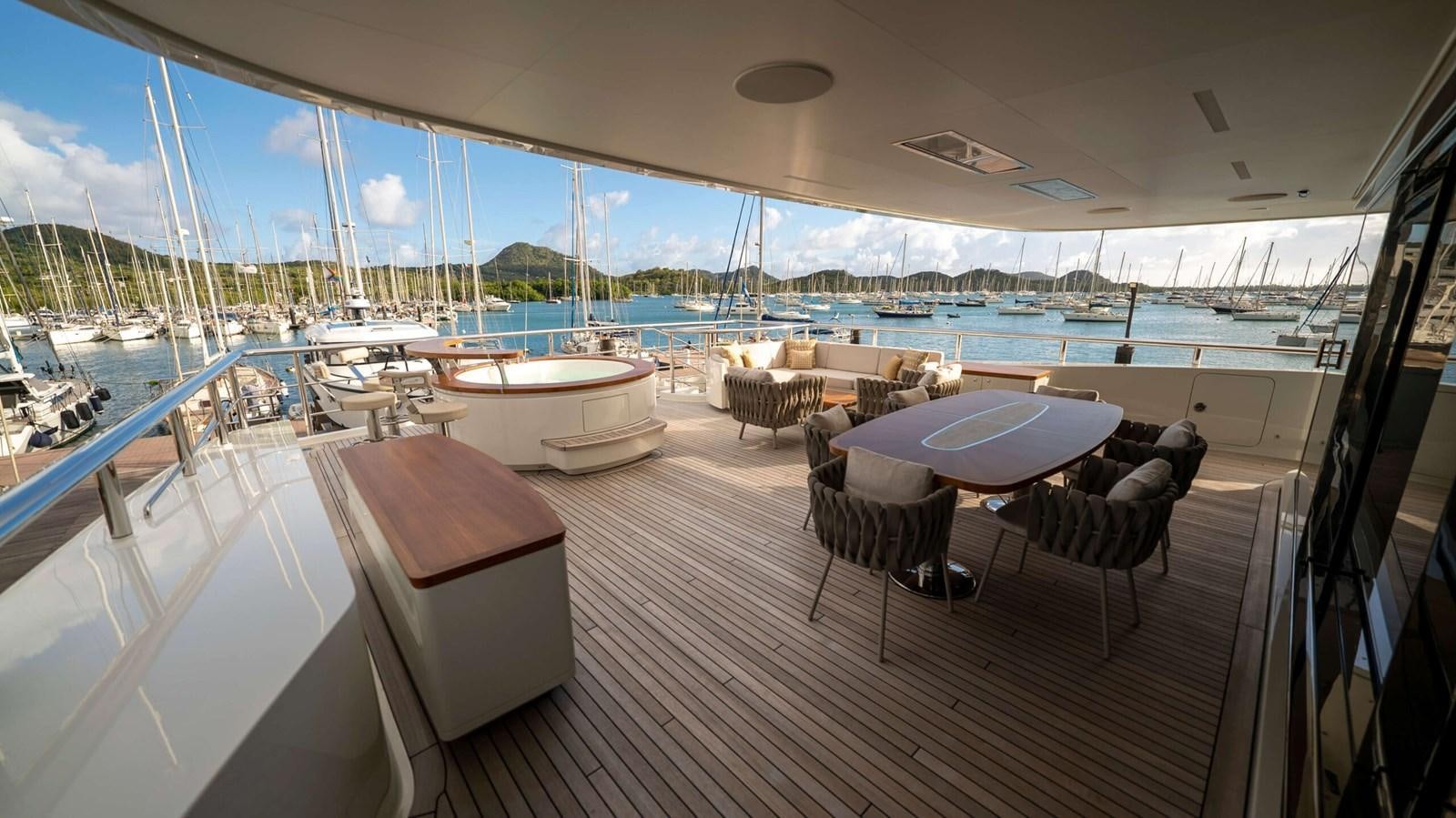 a boat dock with chairs and tables aboard AMIKA Yacht for Sale