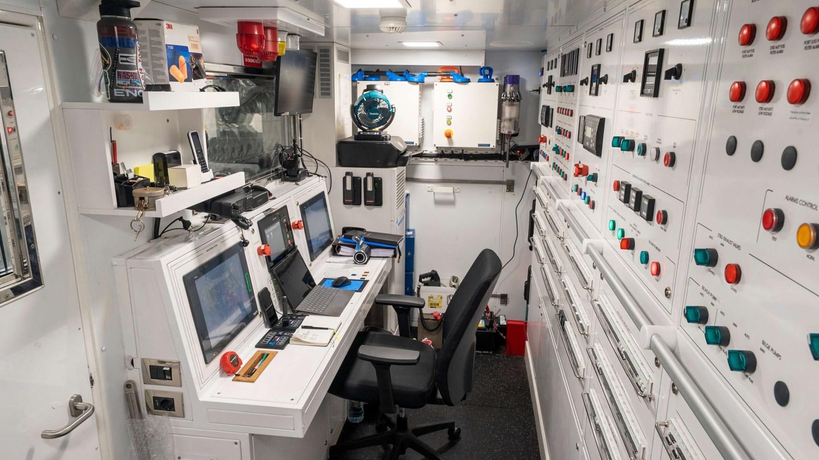 a room with computers and monitors aboard AMIKA Yacht for Sale