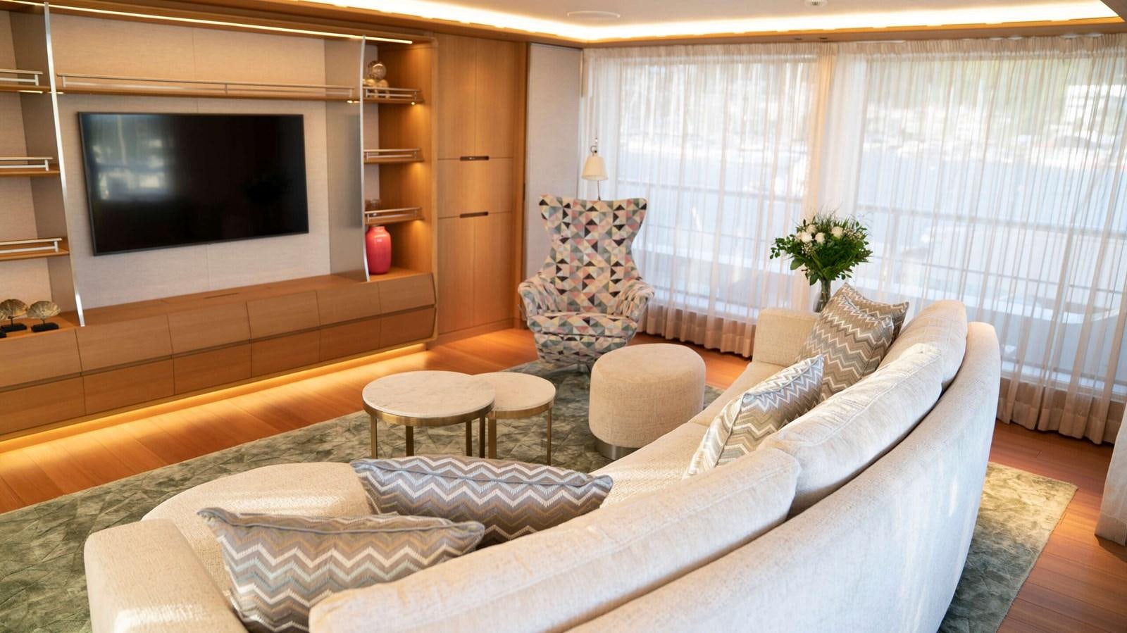 a living room with a large television aboard AMIKA Yacht for Sale