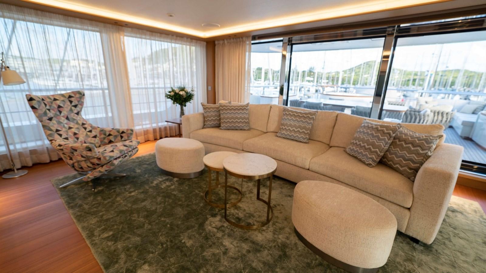 a living room with a large window aboard AMIKA Yacht for Sale