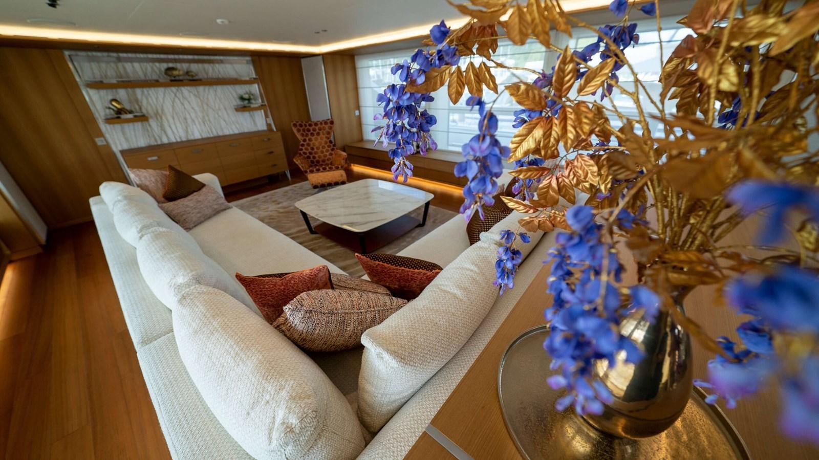 a living room with a large christmas tree aboard AMIKA Yacht for Sale