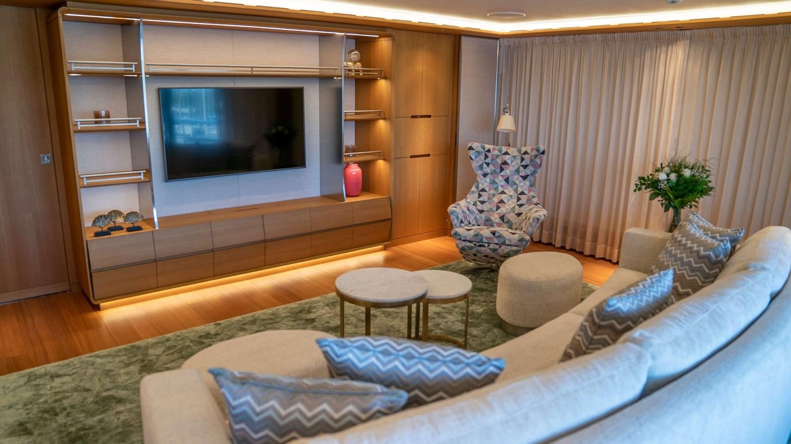 a living room with a large television aboard AMIKA Yacht for Sale