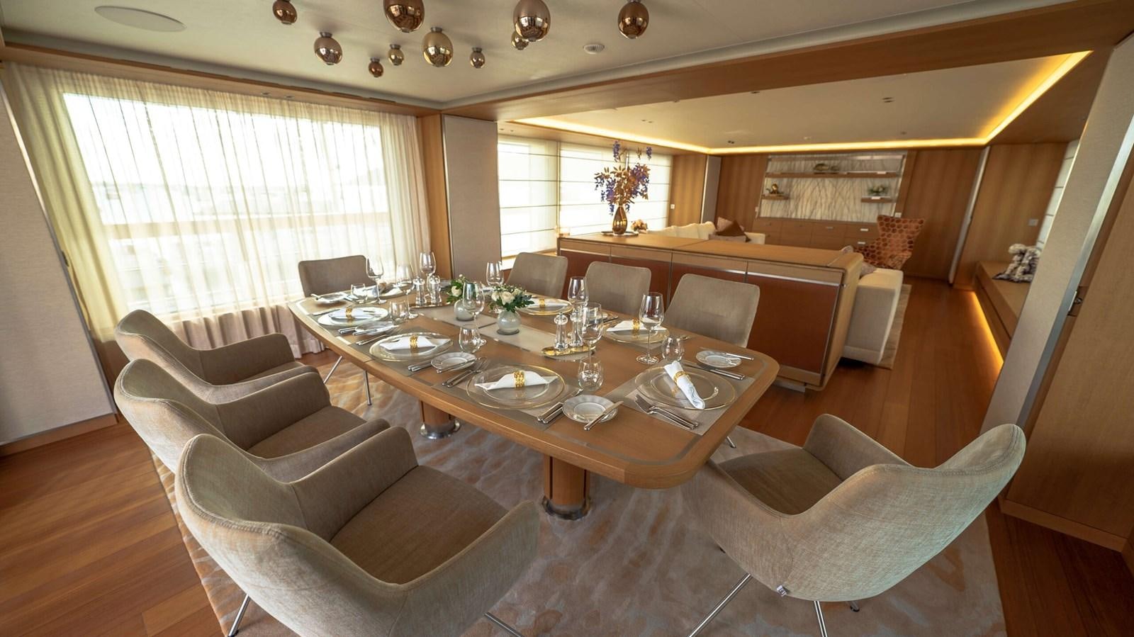 a large dining room with a large table and chairs aboard AMIKA Yacht for Sale