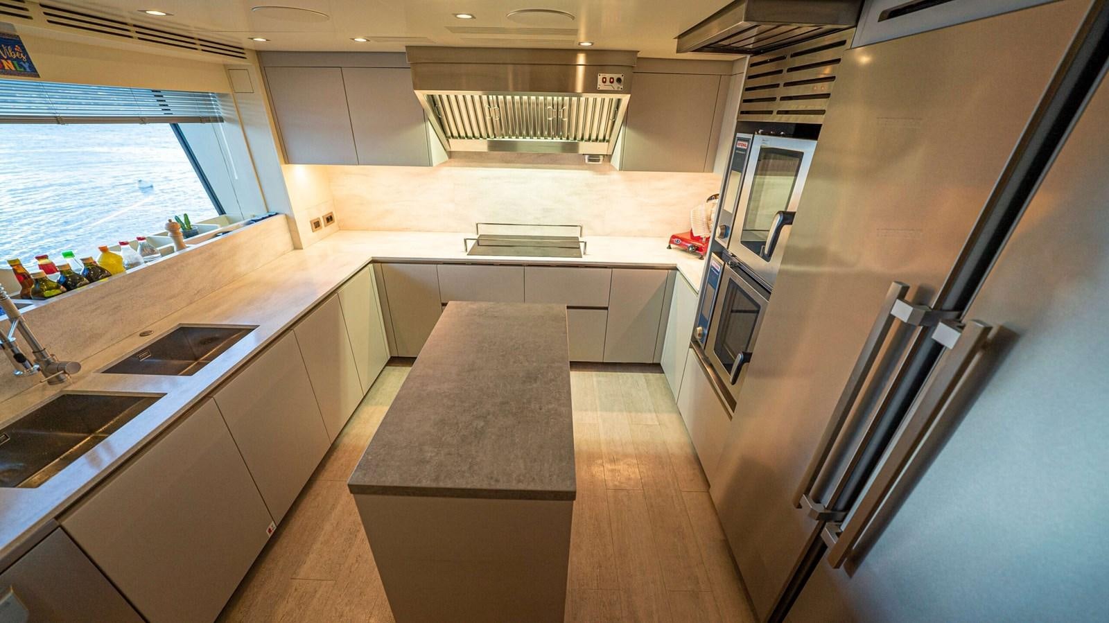 a kitchen with a large island aboard AMIKA Yacht for Sale