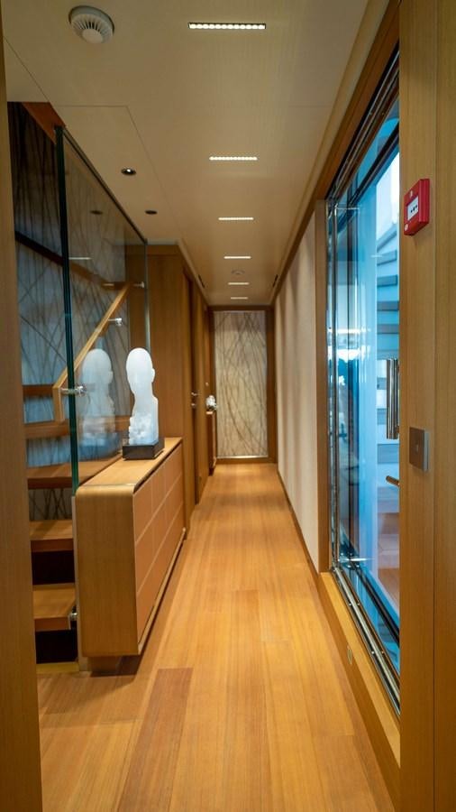 a hallway with a glass door aboard AMIKA Yacht for Sale
