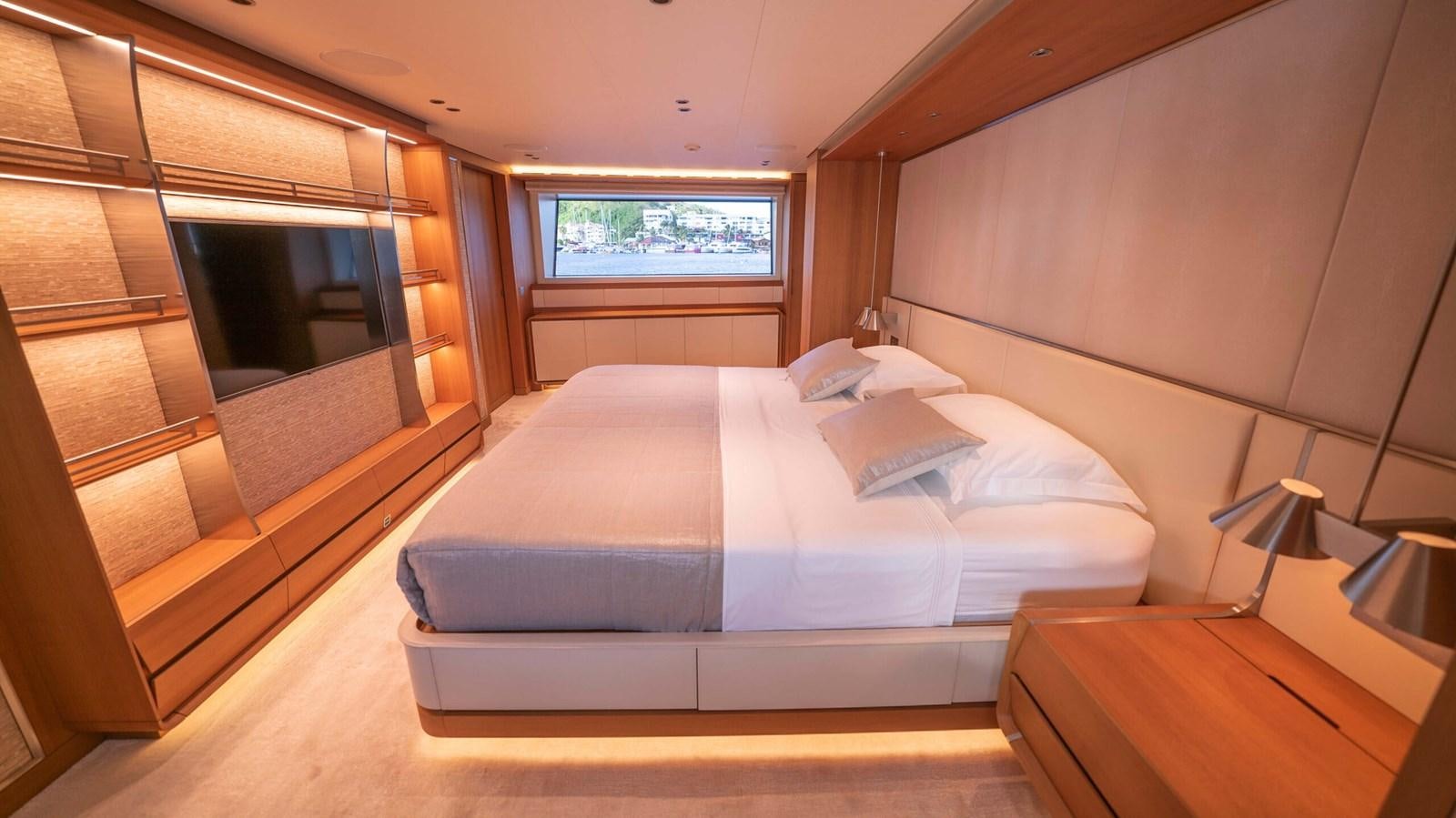 a room with a bed and a window aboard AMIKA Yacht for Sale
