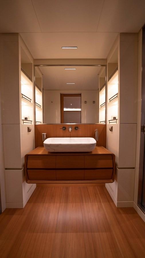a bathroom with a large mirror aboard AMIKA Yacht for Sale