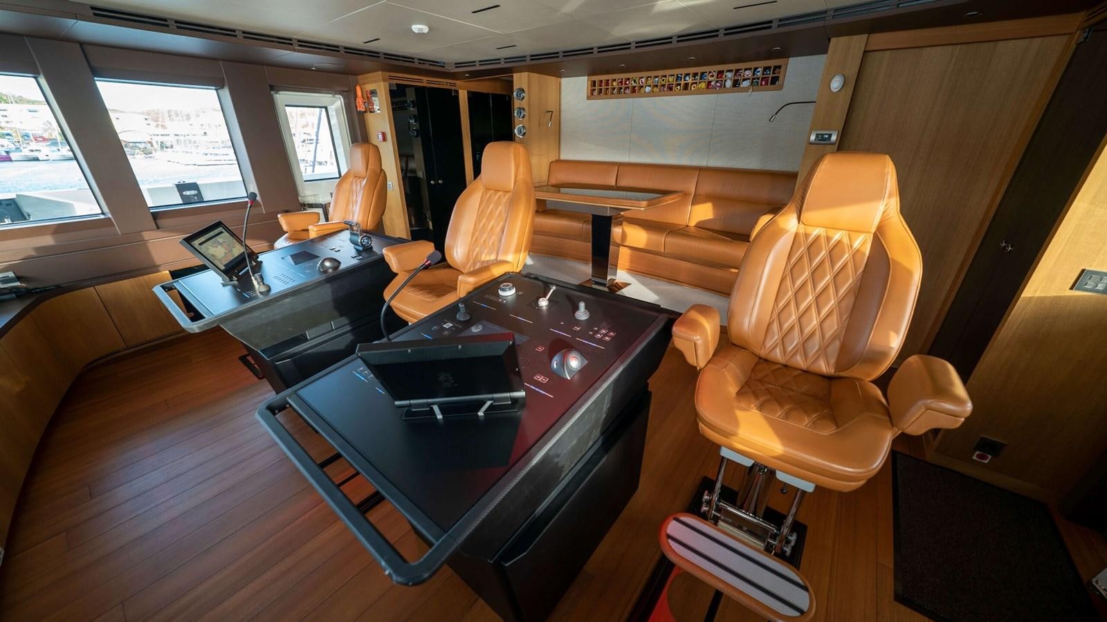 a room with a table and chairs aboard AMIKA Yacht for Sale