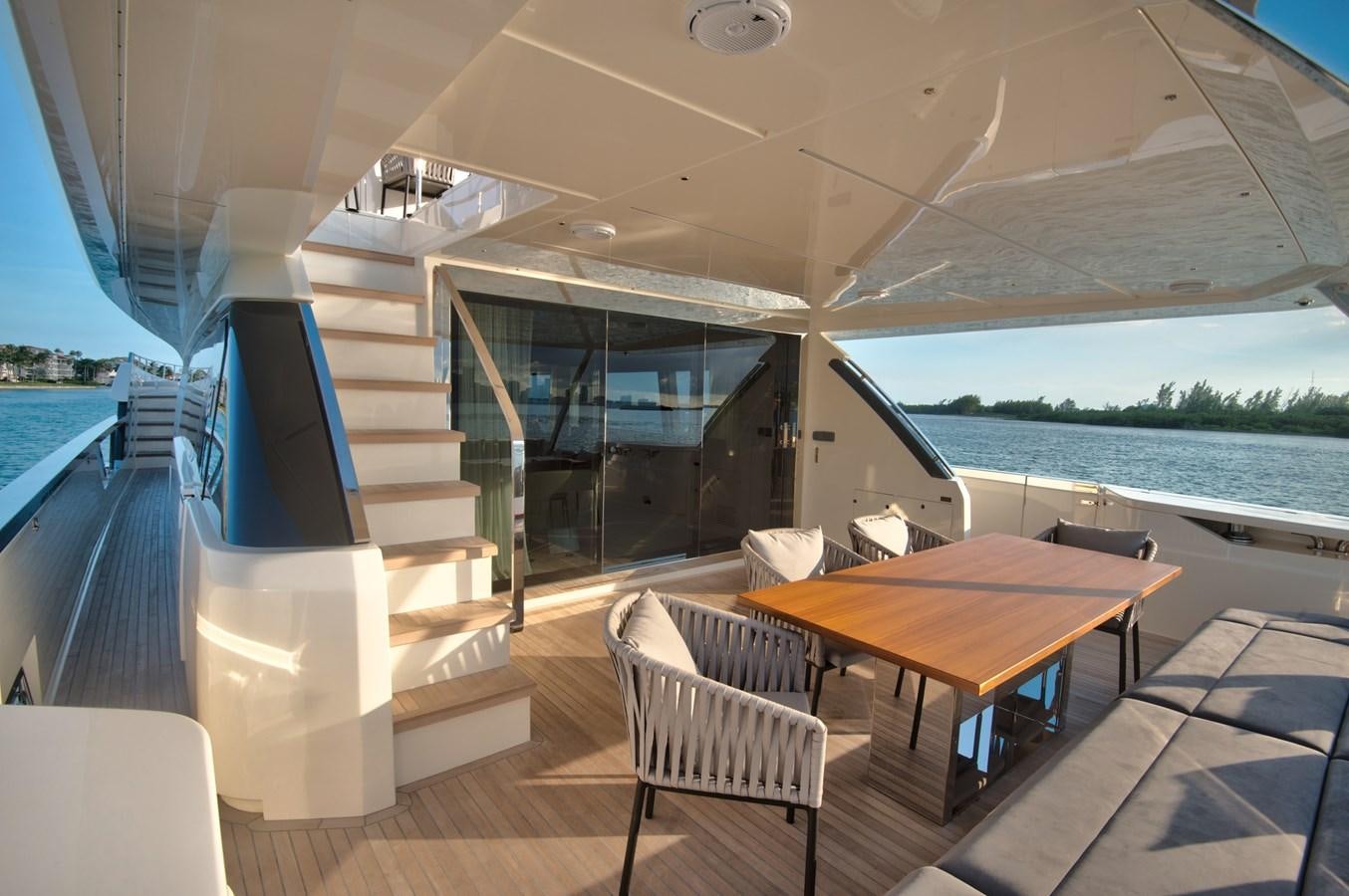 a table and chairs on a boat aboard CIAO II Yacht for Sale